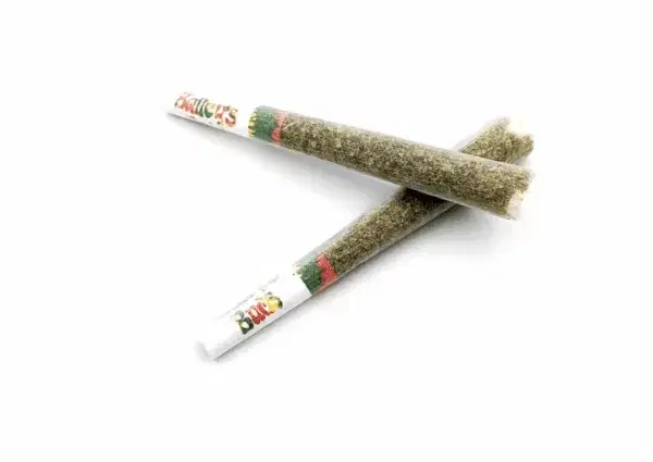 two pre-rolled joints crossed on a white background